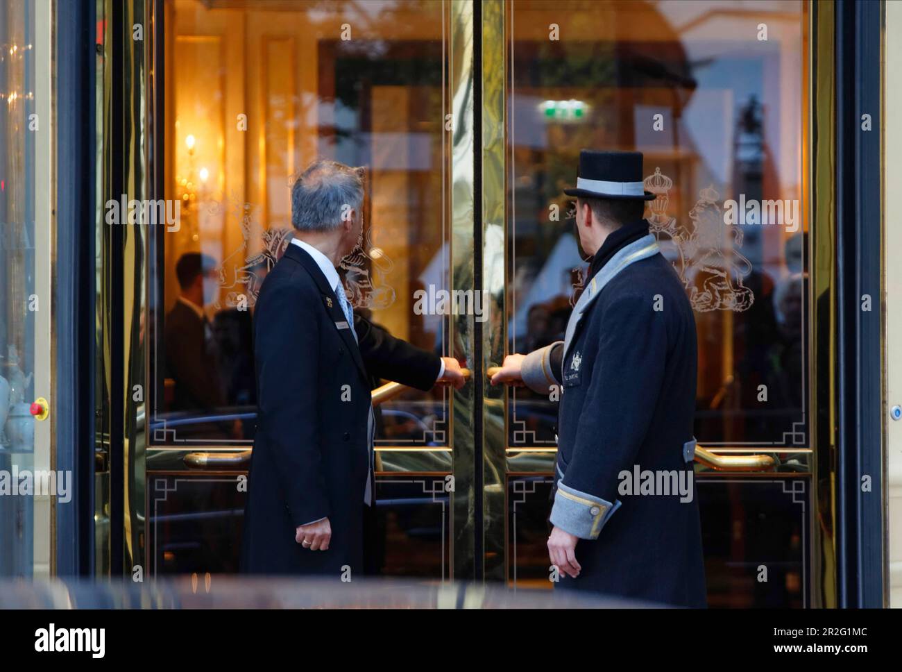 A uniformed car attendant and a concierge of the Hotel Imperial open the hotel door, city view, Vienna, Austria Stock Photo