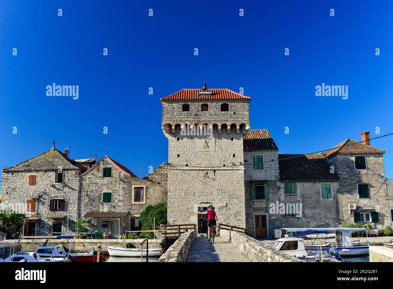 Old weir system with stone houses and bridge at the harbor, near Split