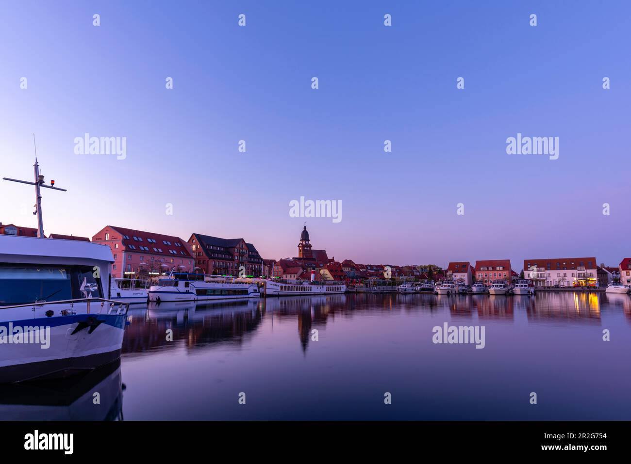 Town harbour of the small town of Waren in the evening light, Mueritz, inland Mueritz, Mecklemburg Lake District, boats, St. Mary's Church Stock Photo
