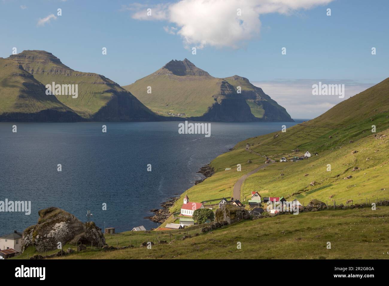 View of Kunoy village and church, Faroe Islands. mountains and fjords. Stock Photo