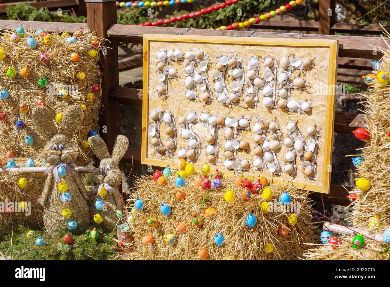 Happy Easter Chalkboard with egg shells at the Easter spring decorated with colorful Easter eggs at the Trubachquelle in Obertrubach in Franconian Swi Stock Photo