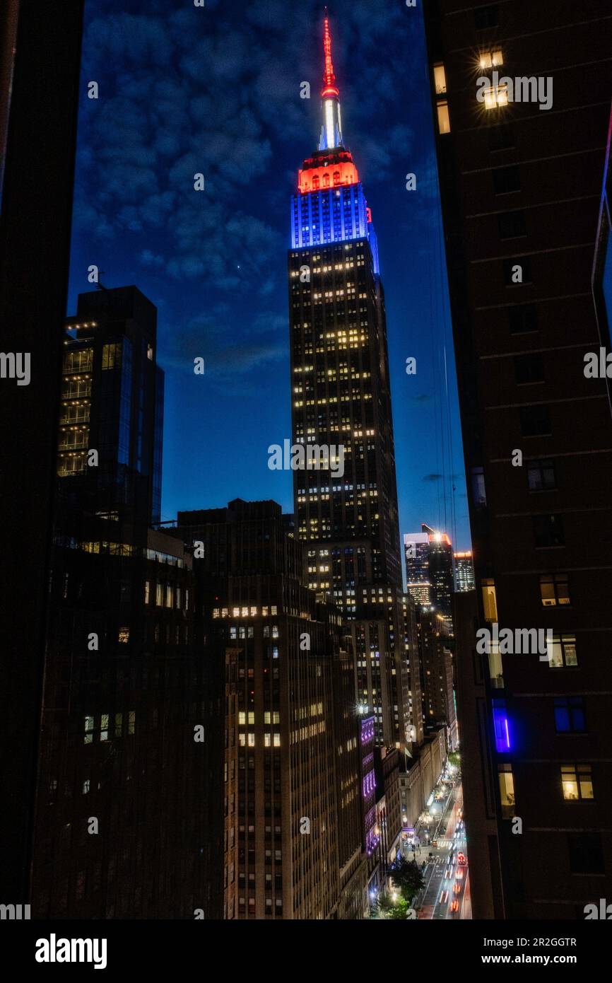 The Empire State building is brightly lit on an early spring evening