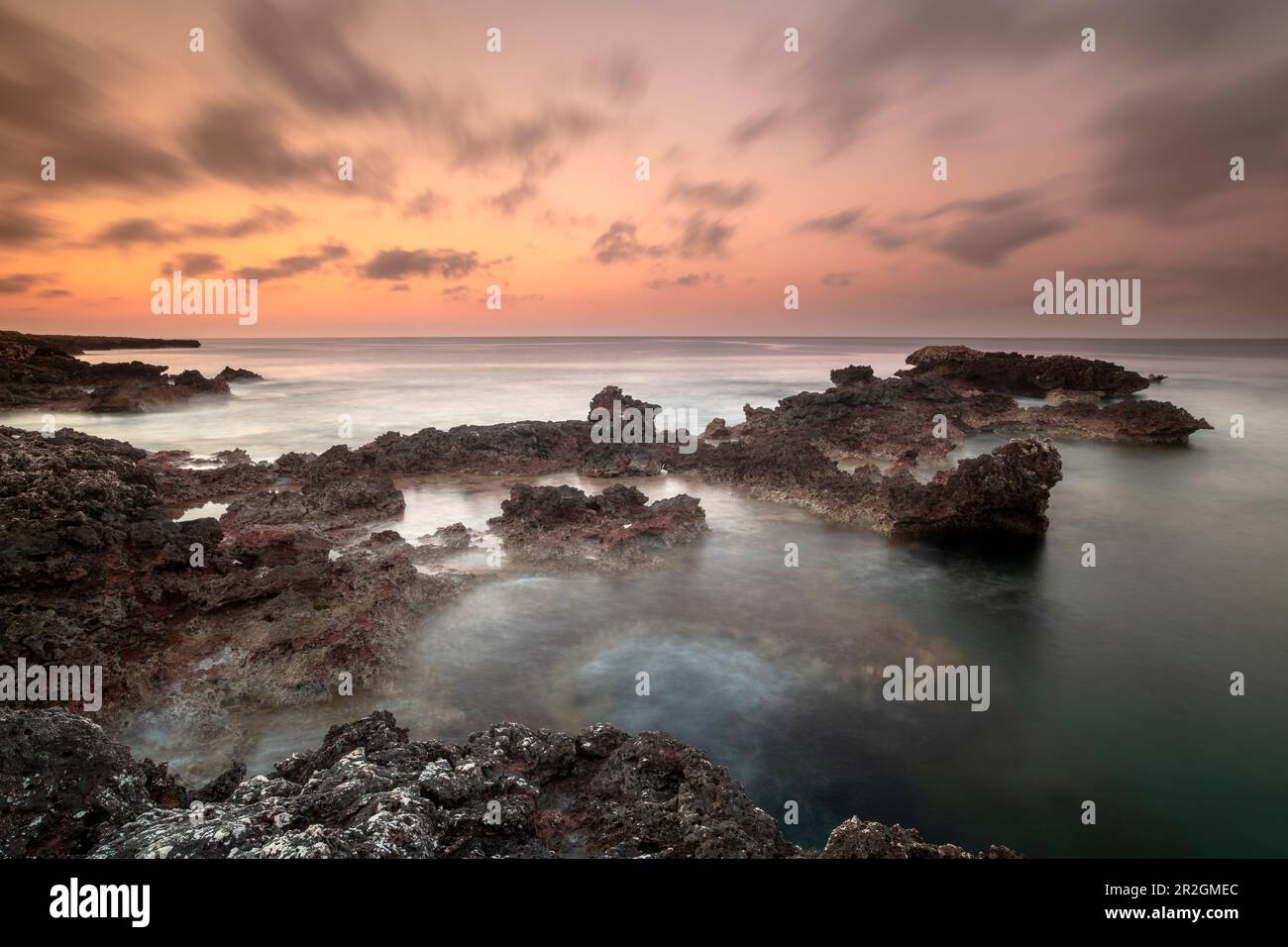 Rocks in the water at Son Xoriguer beach, Spain, Menorca Stock Photo ...