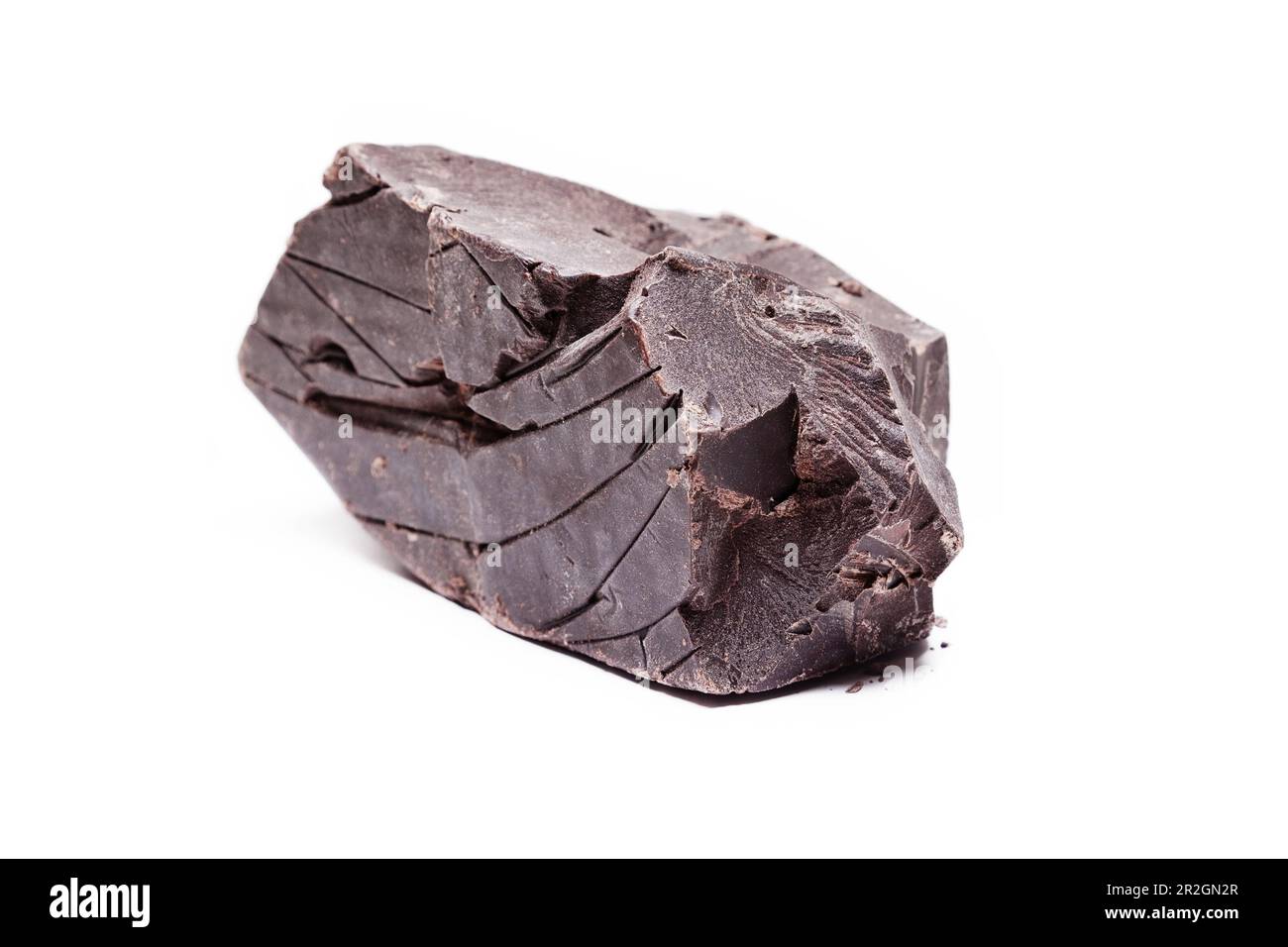 Large piece of raw, dark chocolate isolated on white background Stock Photo