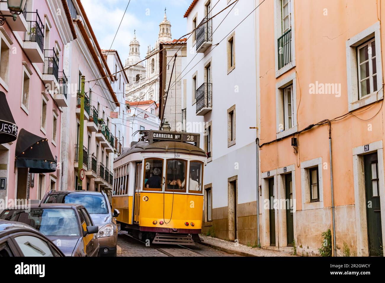 The 28E tram goes through a steep and narrow street in the old town