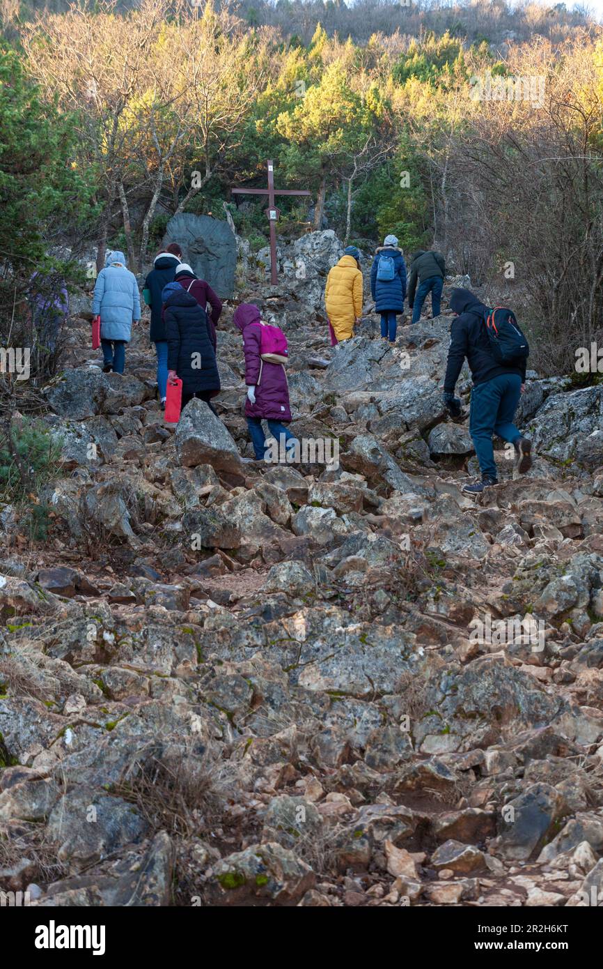A group of young people climbing Mount Križevac in Medjugorje on a cold February morning. Stock Photo