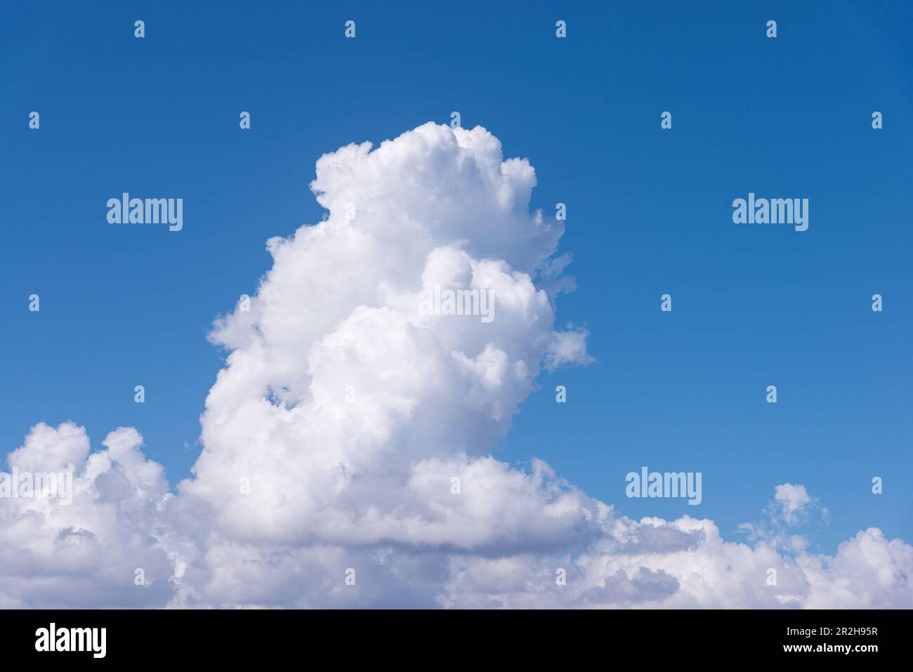 Cumulus white clouds in clear blue sky background Stock Photo - Alamy