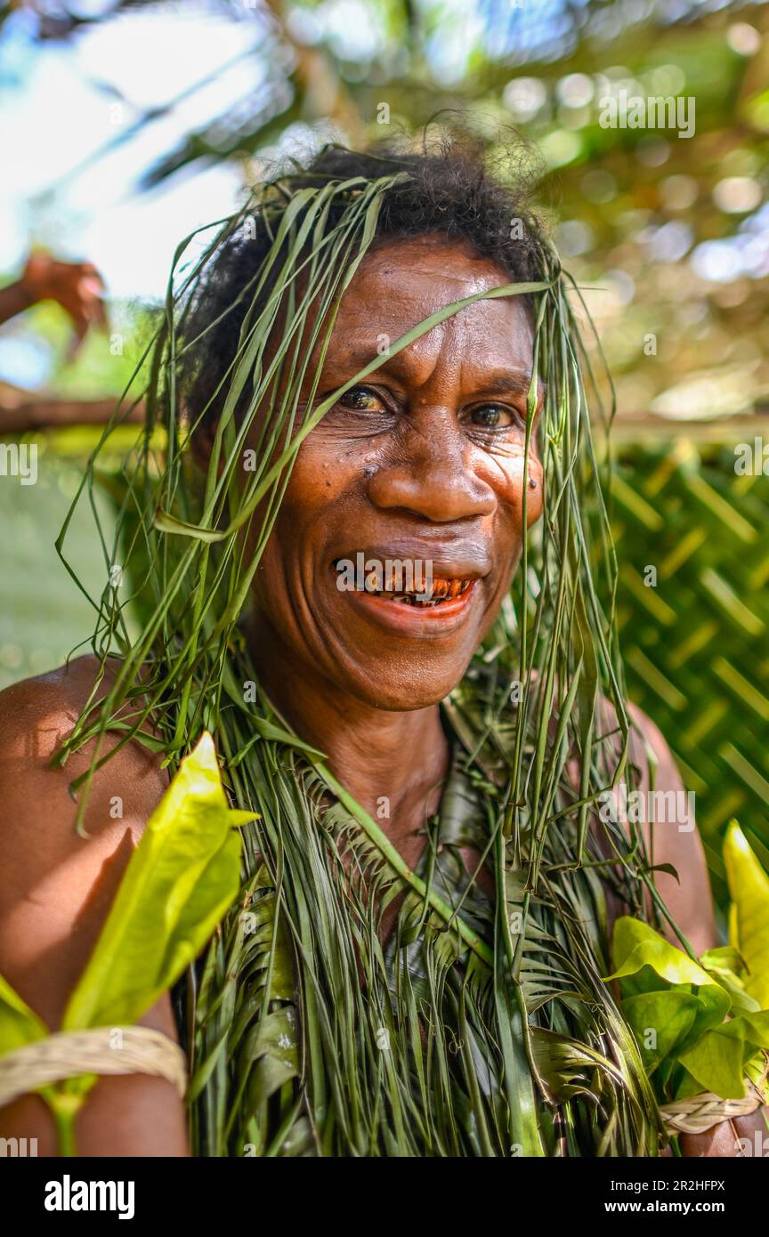 In the Solomon Islands, it is a cultural practice for some people, particularly in certain communities, to have red-stained teeth. This practice is known as 'betel nut chewing' or 'buai chewing.'  Betel nut is a fruit of the Areca palm tree, which is commonly chewed in many parts of Asia and the Pacific, including the Solomon Islands. When the betel nut is chewed, it releases a red juice that stains the teeth and mouth. Stock Photo