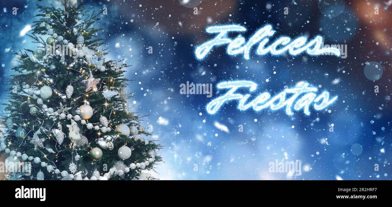 Felices Fiestas. Festive greeting card with happy holiday's wishes in Spanish and Christmas tree on bright background Stock Photo