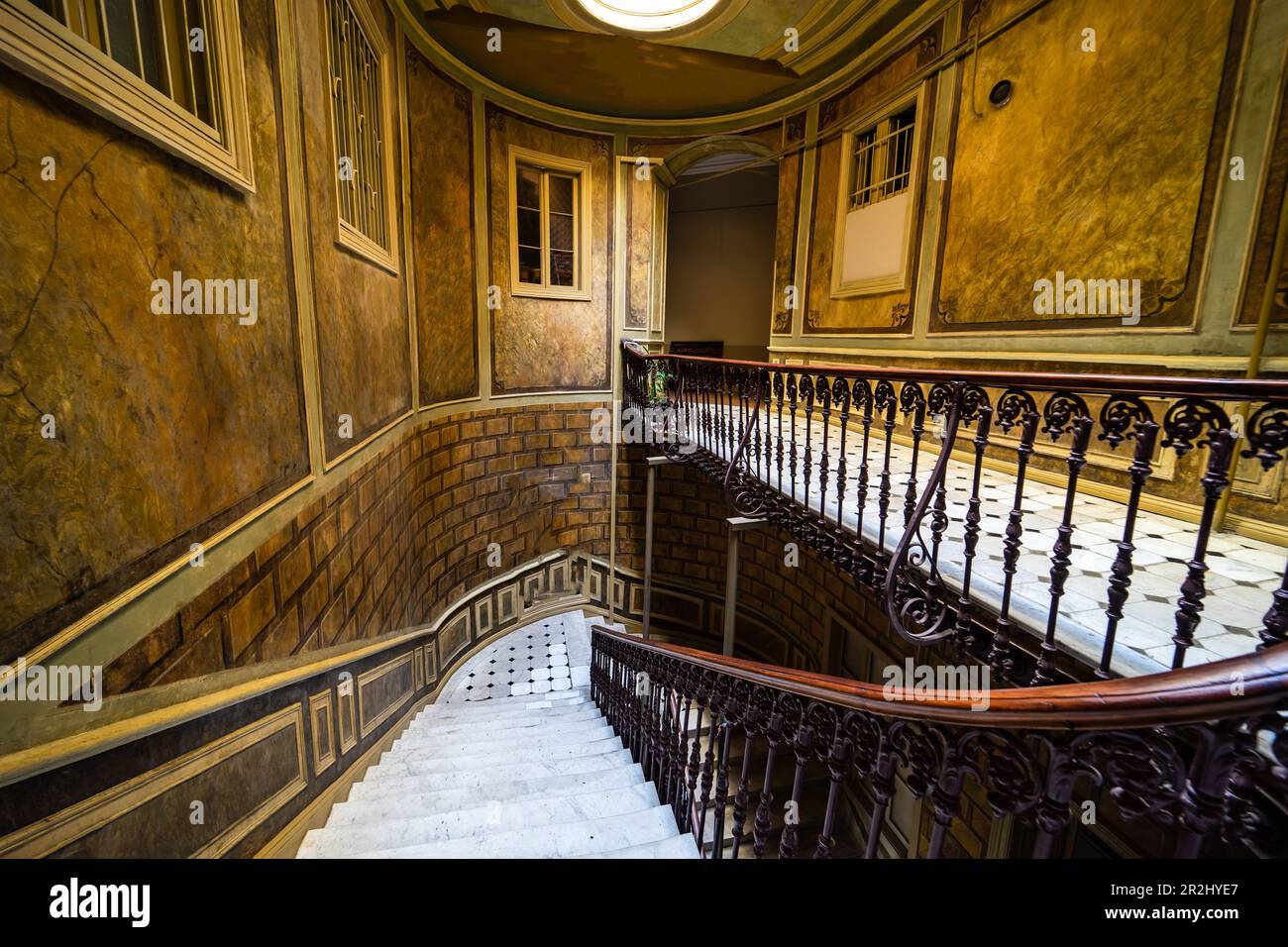 Interior of entrance hall with carved staircase in old maisons in
