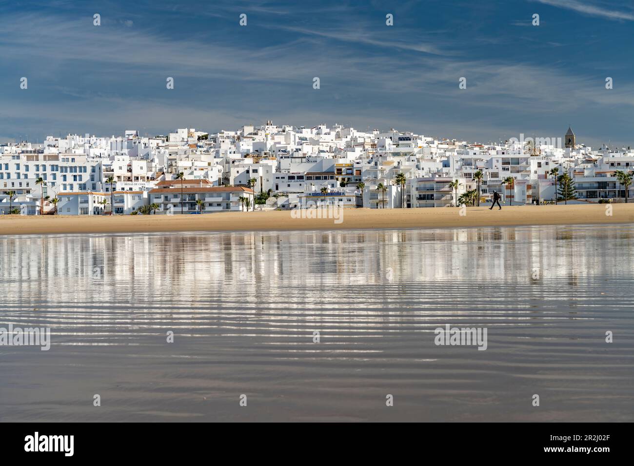 Conil cityscape reflected on Playa De Los Bateles beach, Conil de la Frontera, Costa de la Luz, Andalusia, Spain Stock Photo