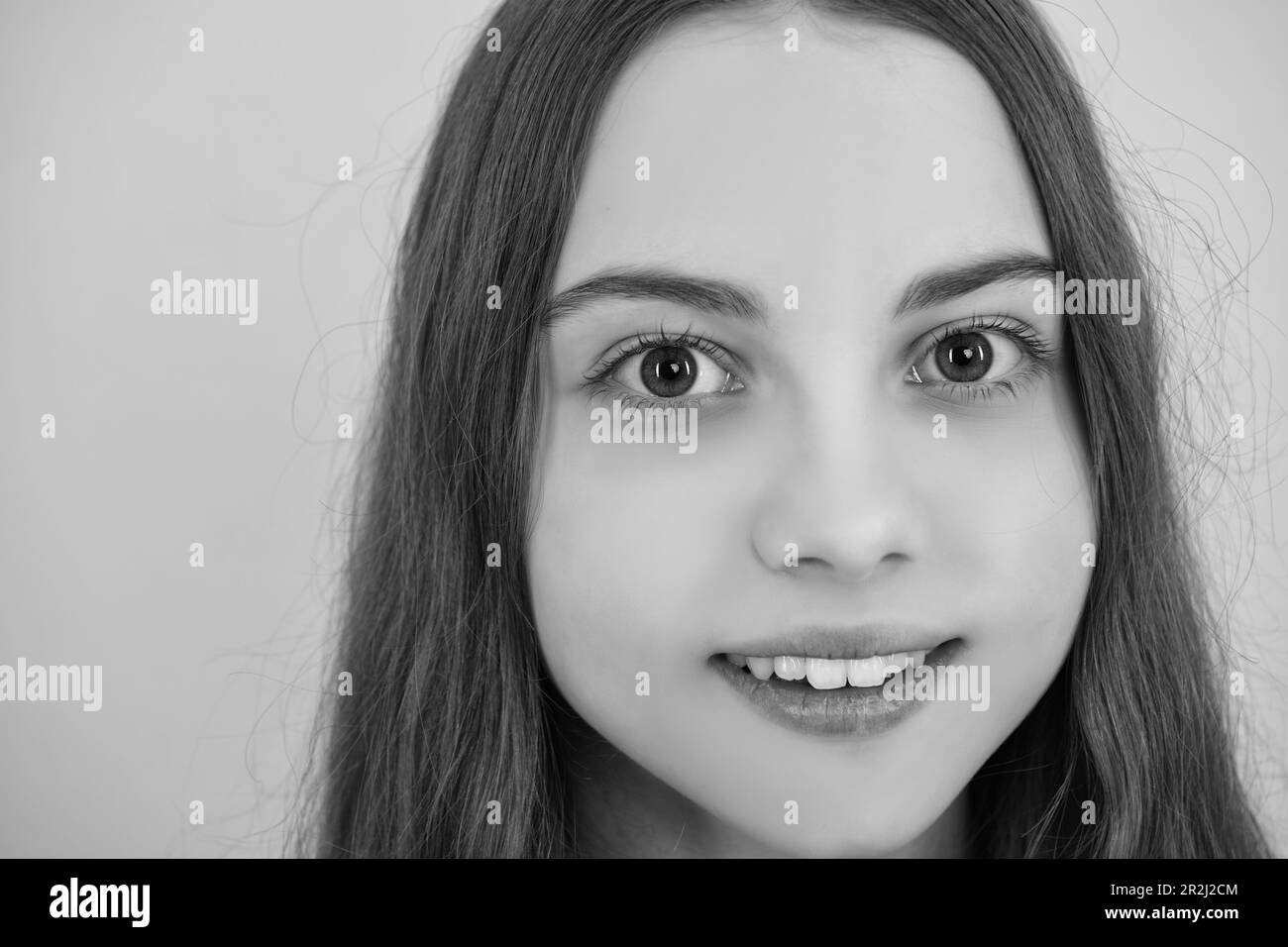 Close up portrait of caucasian teen girl. Head shot of cute teenager child on yellow isolated