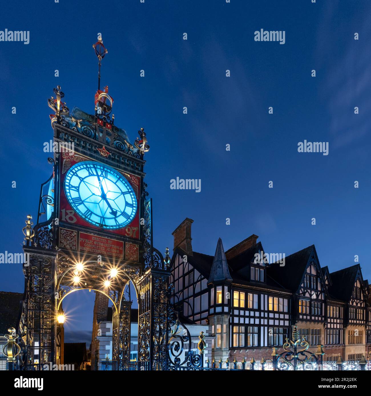 The Victorian Eastgate Clock on the city walls at night, Eastgate Street, Chester, Cheshire, England, United Kingdom, Europe Stock Photo