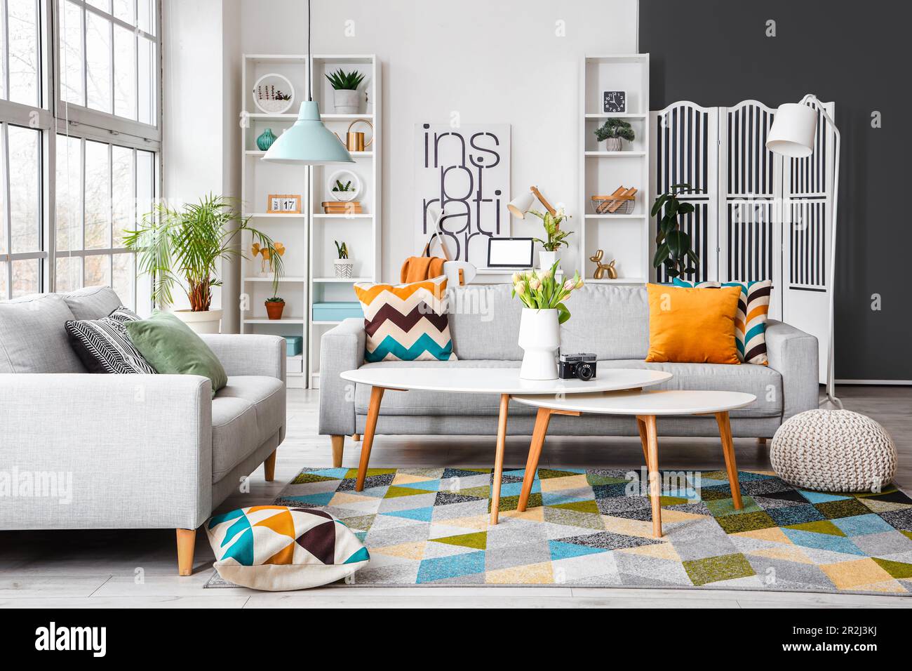 Interior of bright living room with cozy sofas and coffee table near ...