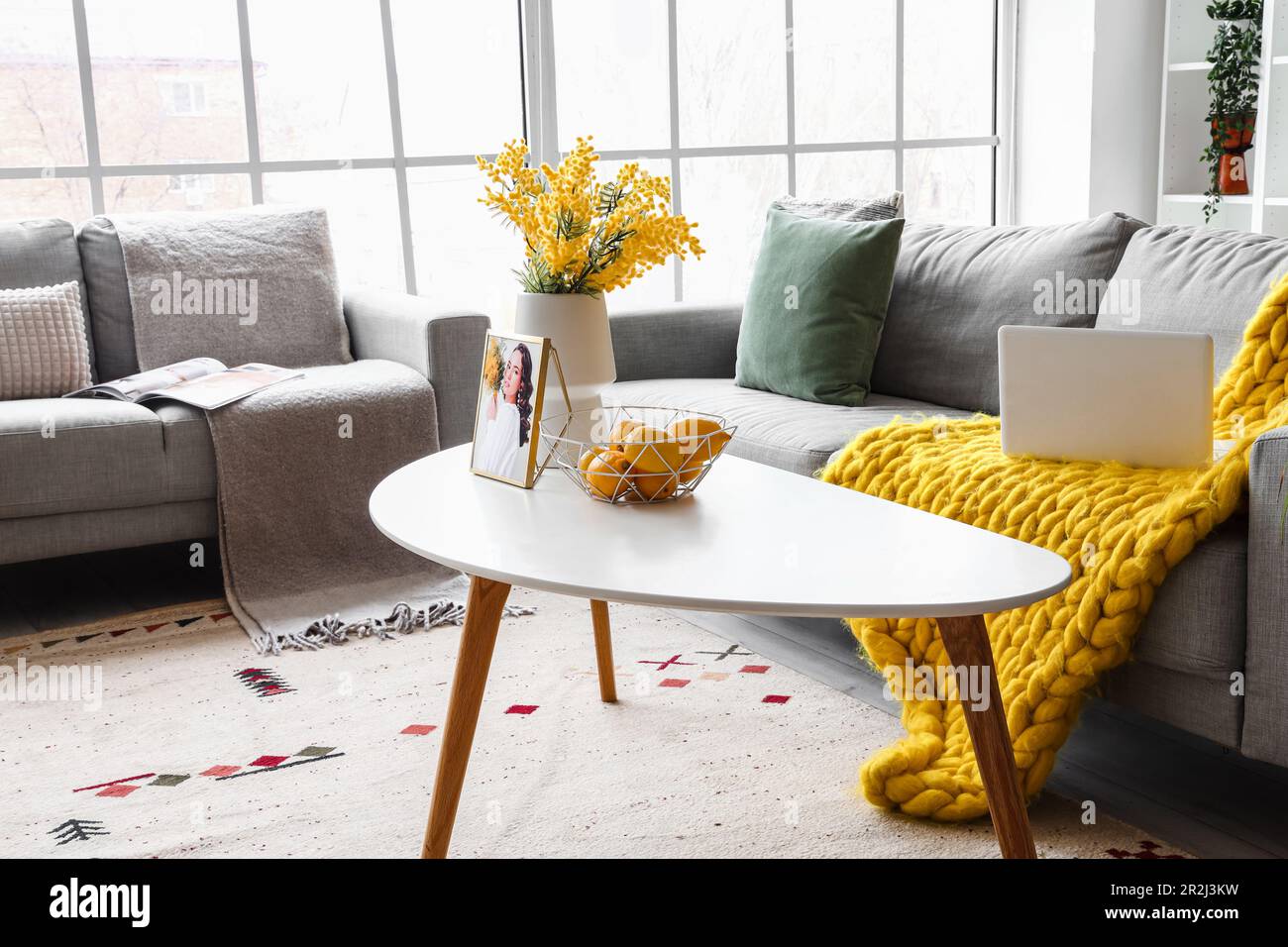 Interior of bright living room with cozy sofas near big window Stock ...