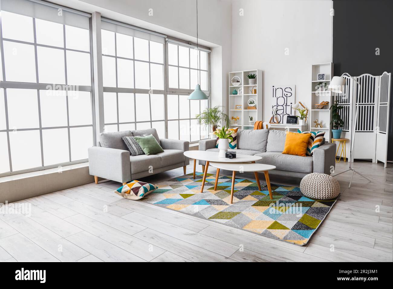 Interior of bright living room with cozy sofas and coffee table near ...