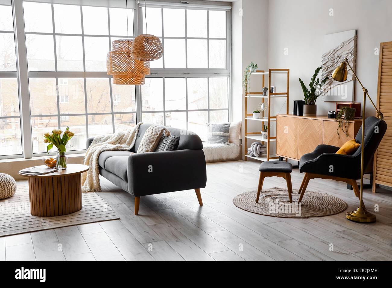 Interior of stylish living room with cozy sofa and coffee table near ...