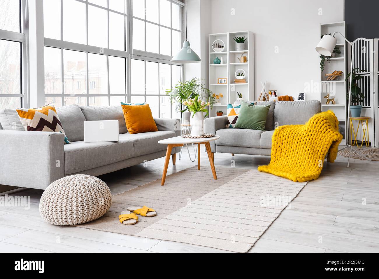 Interior of bright living room with cozy sofas and coffee table near ...