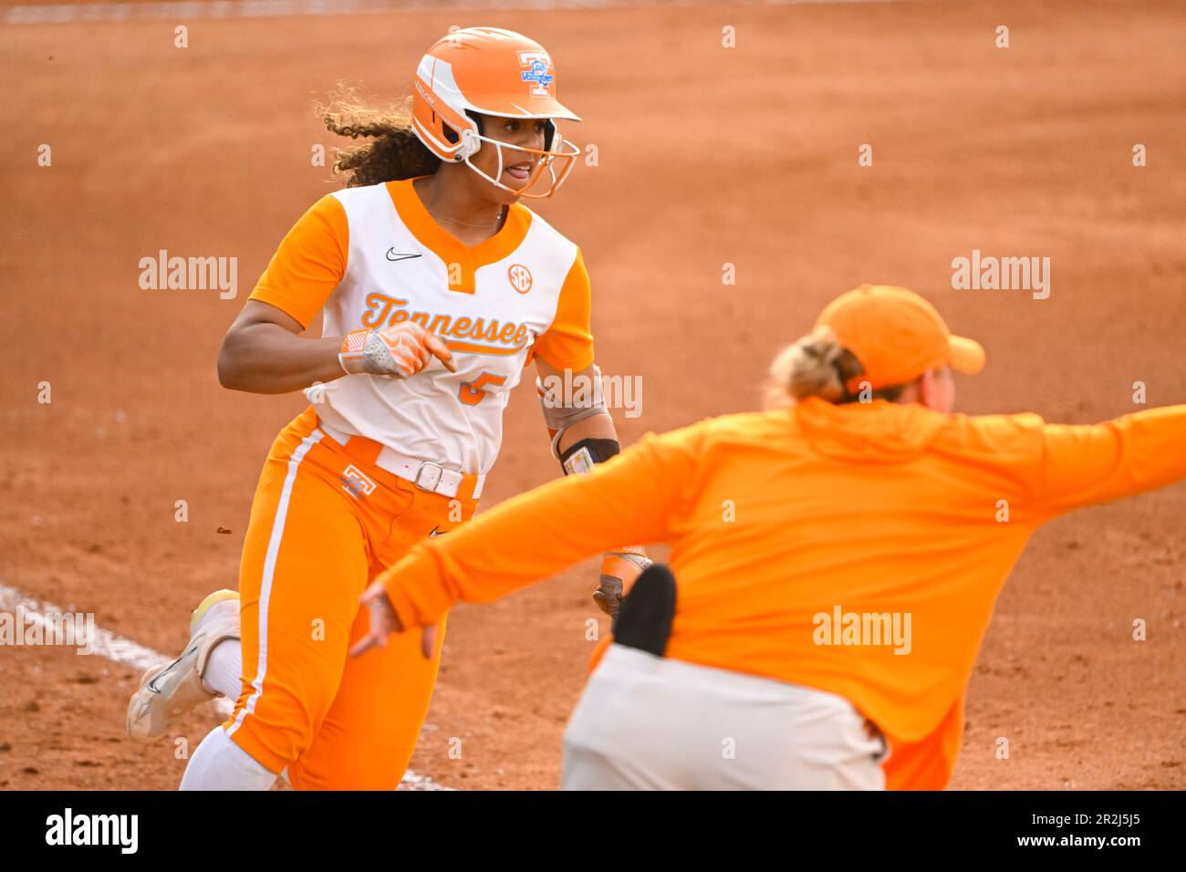 Tennessee player Rylie West is sent to home plate to score against