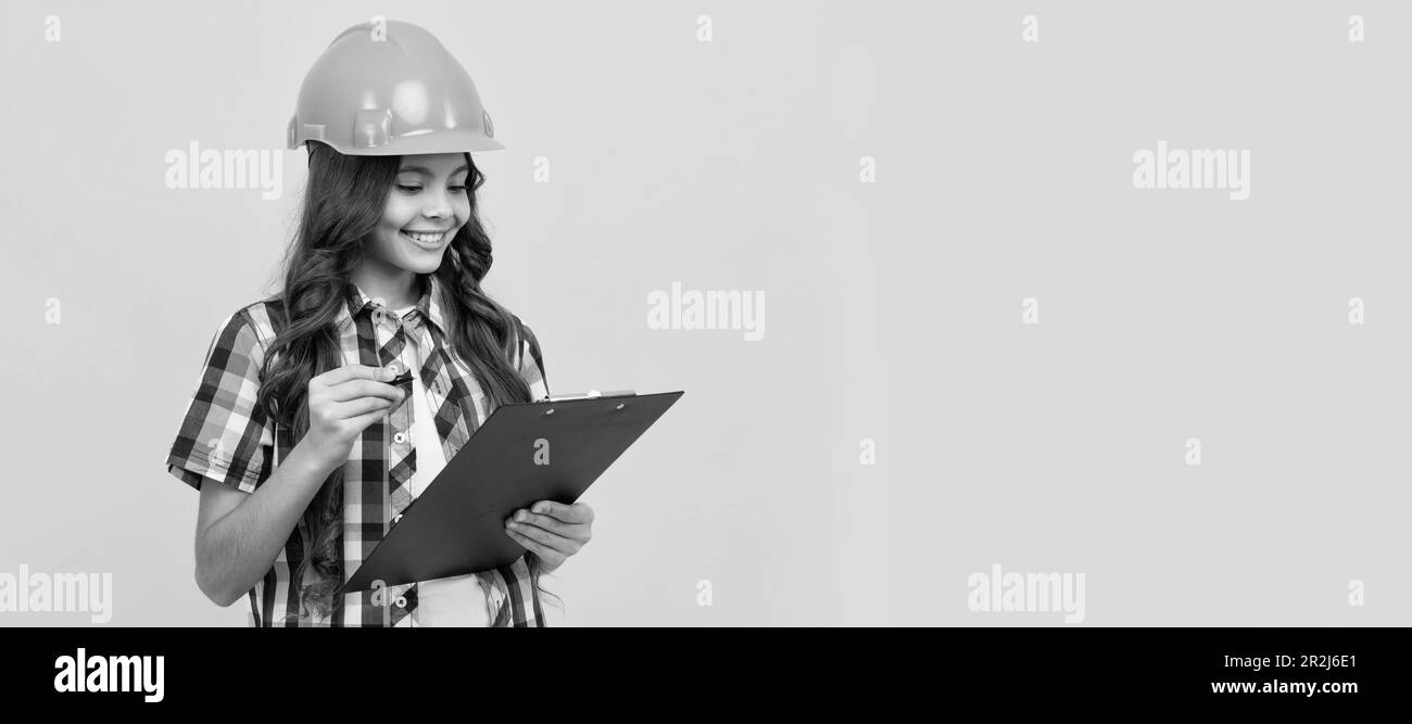 future engineer hold clipboard. safety work expertise. teen girl in protective hard hat. Child
