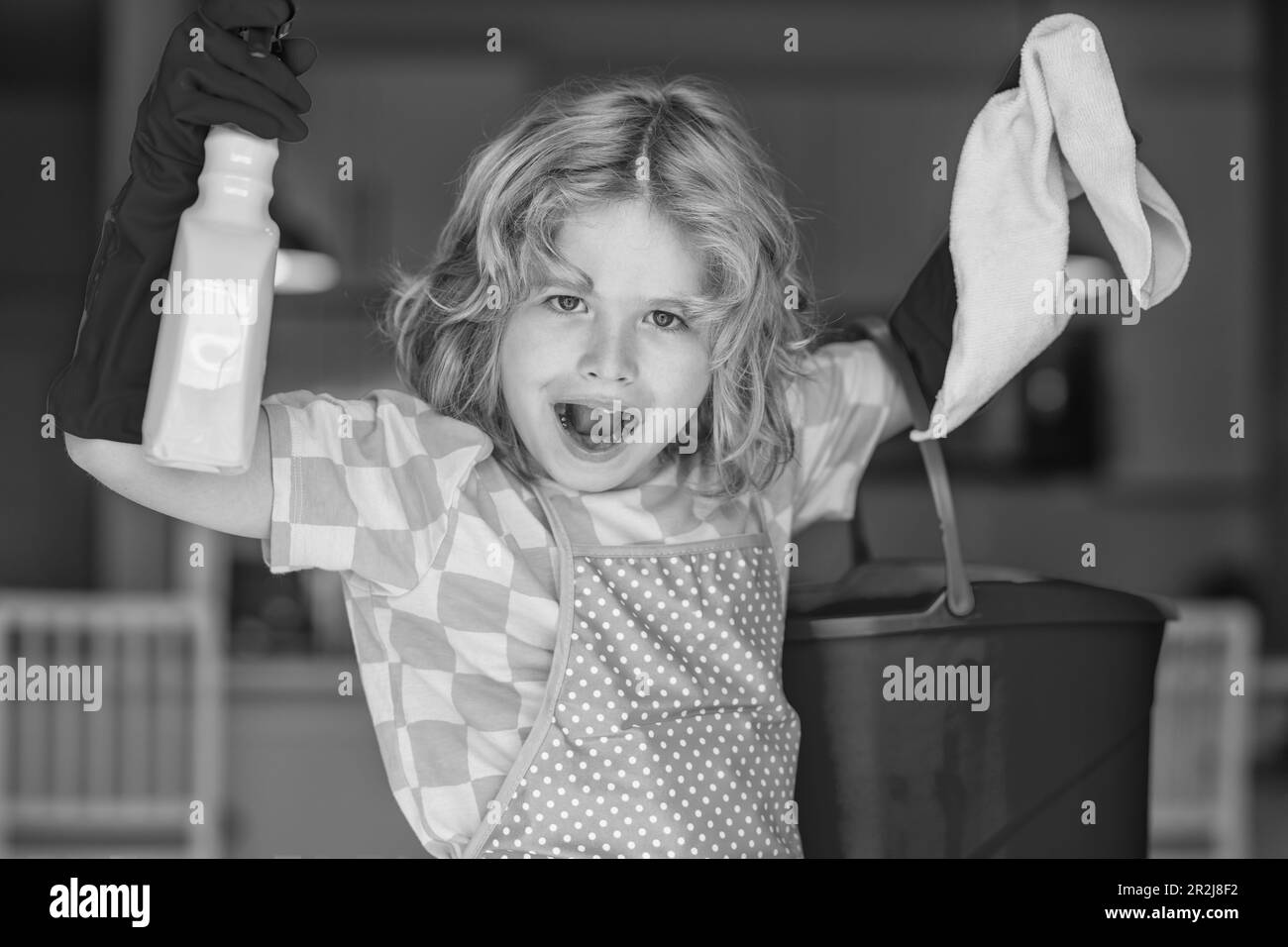 Portrait of child helping with housework, cleaning the house. Housekeeping, home chores Stock Photo
