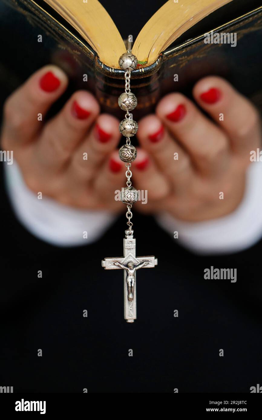 Woman reading the Bible, close up on vintage rosary with crucifix, Faith and religion, France, Europe Stock Photo