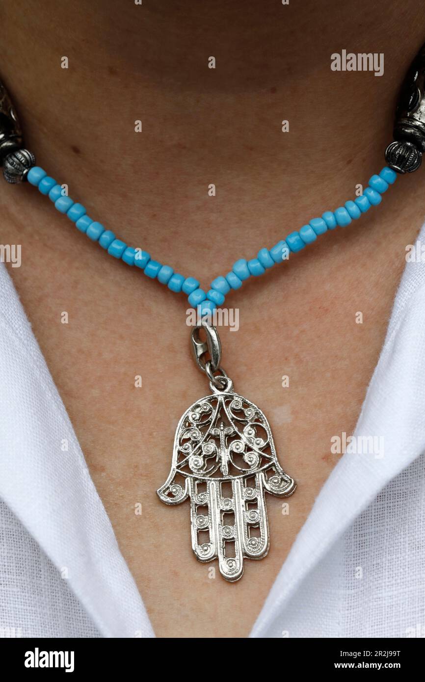 Woman wearing a Muslim hamsa amulet (the Hand of Fatima) (the Hand of Mary), Vietnam, Indochina, Southeast Asia, Asia Stock Photo