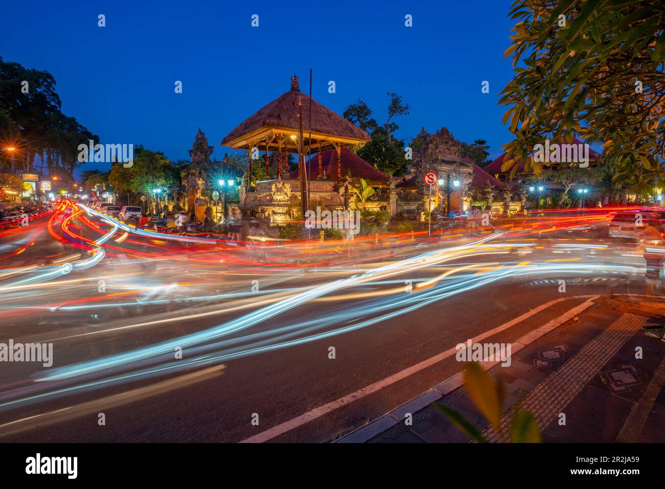 View of car trail lights and Ubud Palace at dusk, Ubud, Kabupaten Gianyar, Bali, Indonesia, South East Asia, Asia Stock Photo