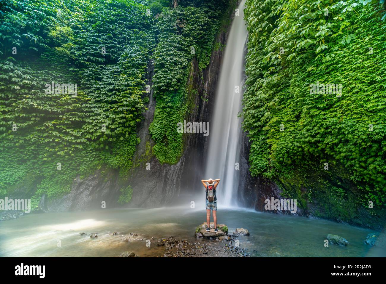 View of woman taking picture at Melanting waterfall, Kabupaten Buleleng, Gobleg, Bali, Indonesia, South East Asia, Asia Stock Photo