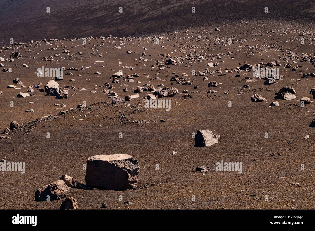 A flank of the Pico do Fogo volcano on the island of Fogo, Cape Verde, covered with stones and lava boulders Stock Photo