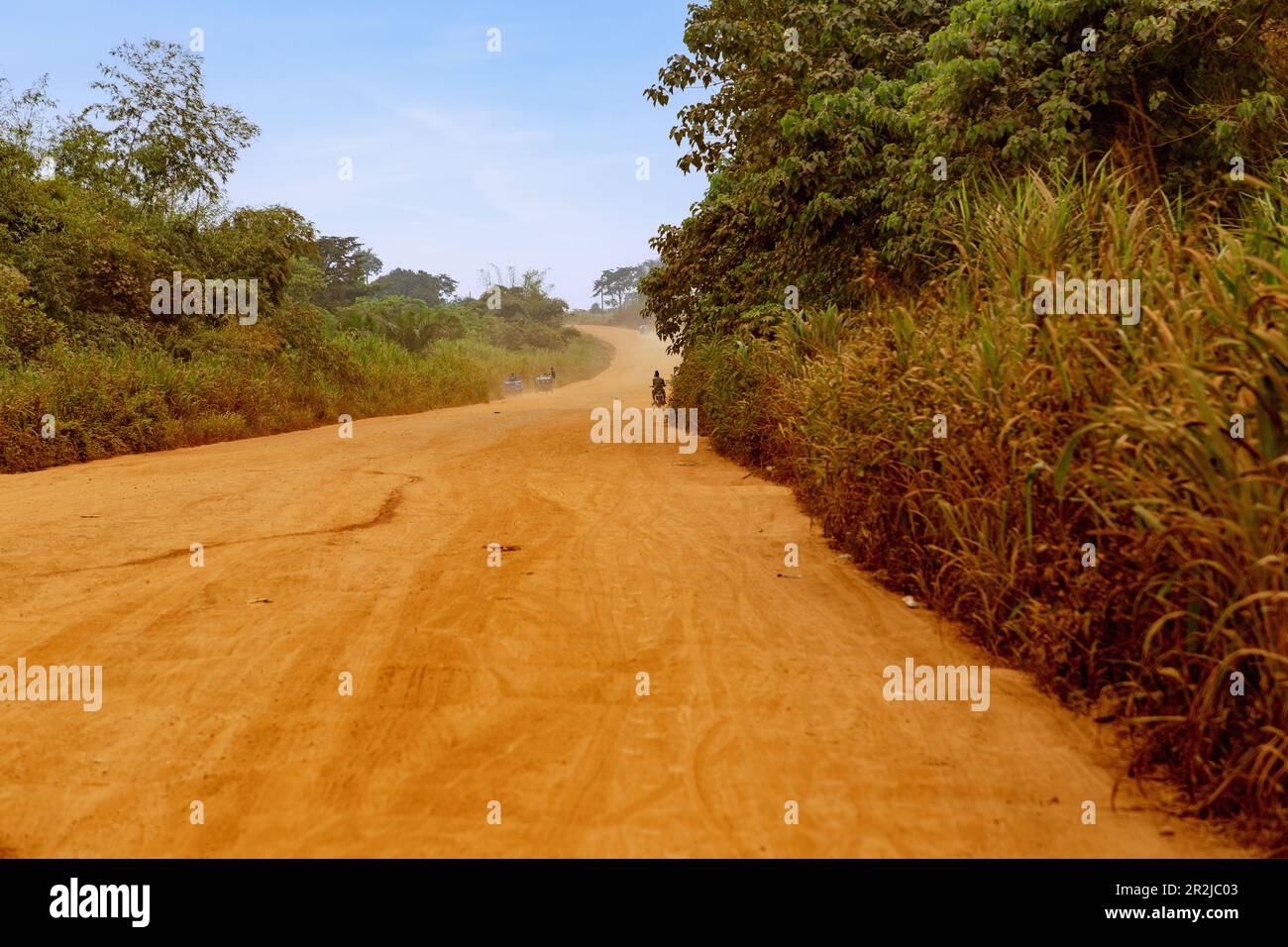 red sand track, road to Hohoe in the Volta Region of eastern Ghana in West Africa Stock Photo