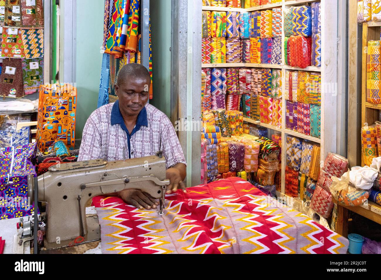 Tailors for traditional kente fabrics in the central market in Kumasi in the Ashanti region of central Ghana in West Africa Stock Photo
