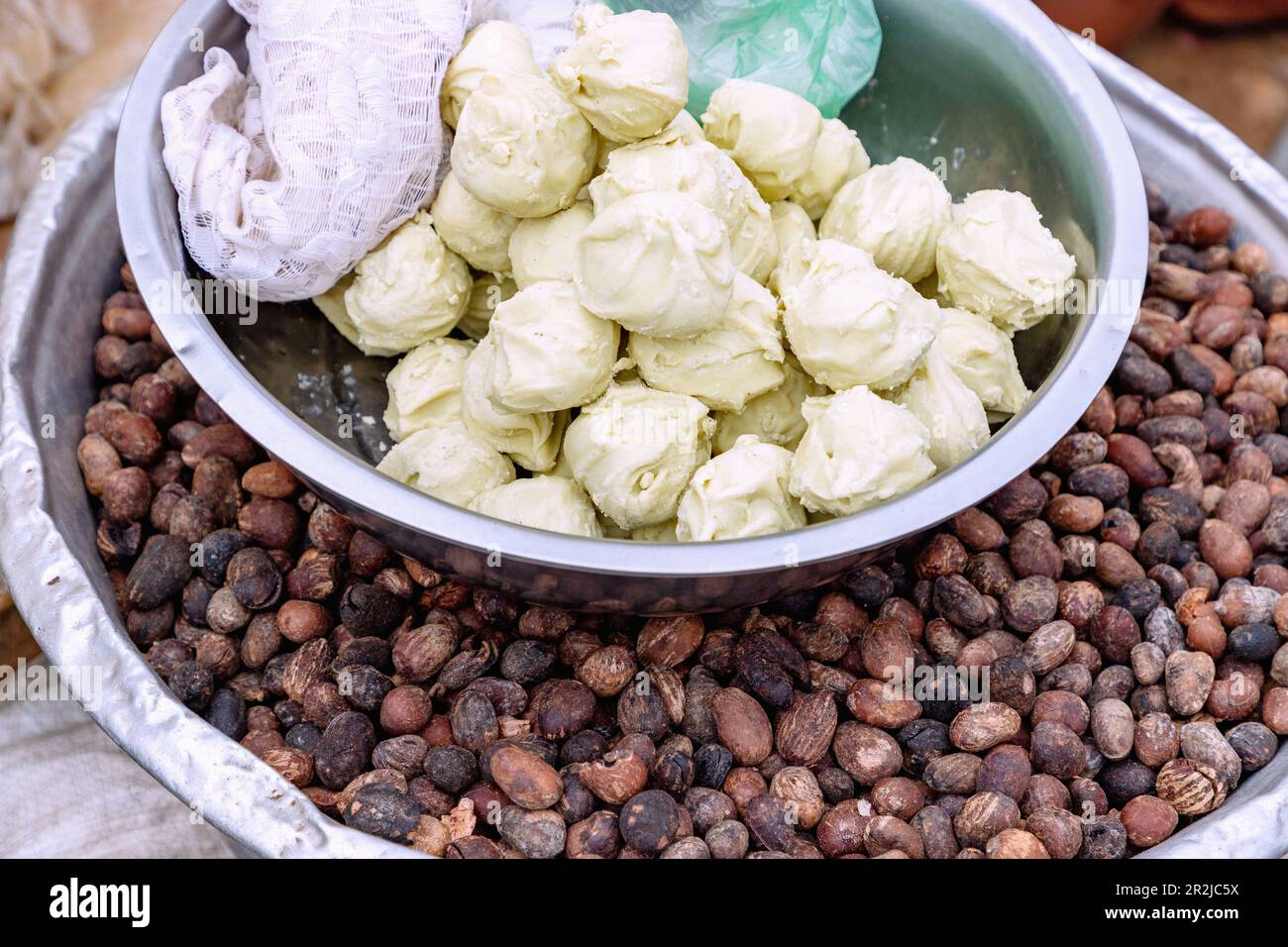 Corn dumplings and cocoa beans at the market in Sawla in the Savannah region of central Ghana in West Africa Stock Photo