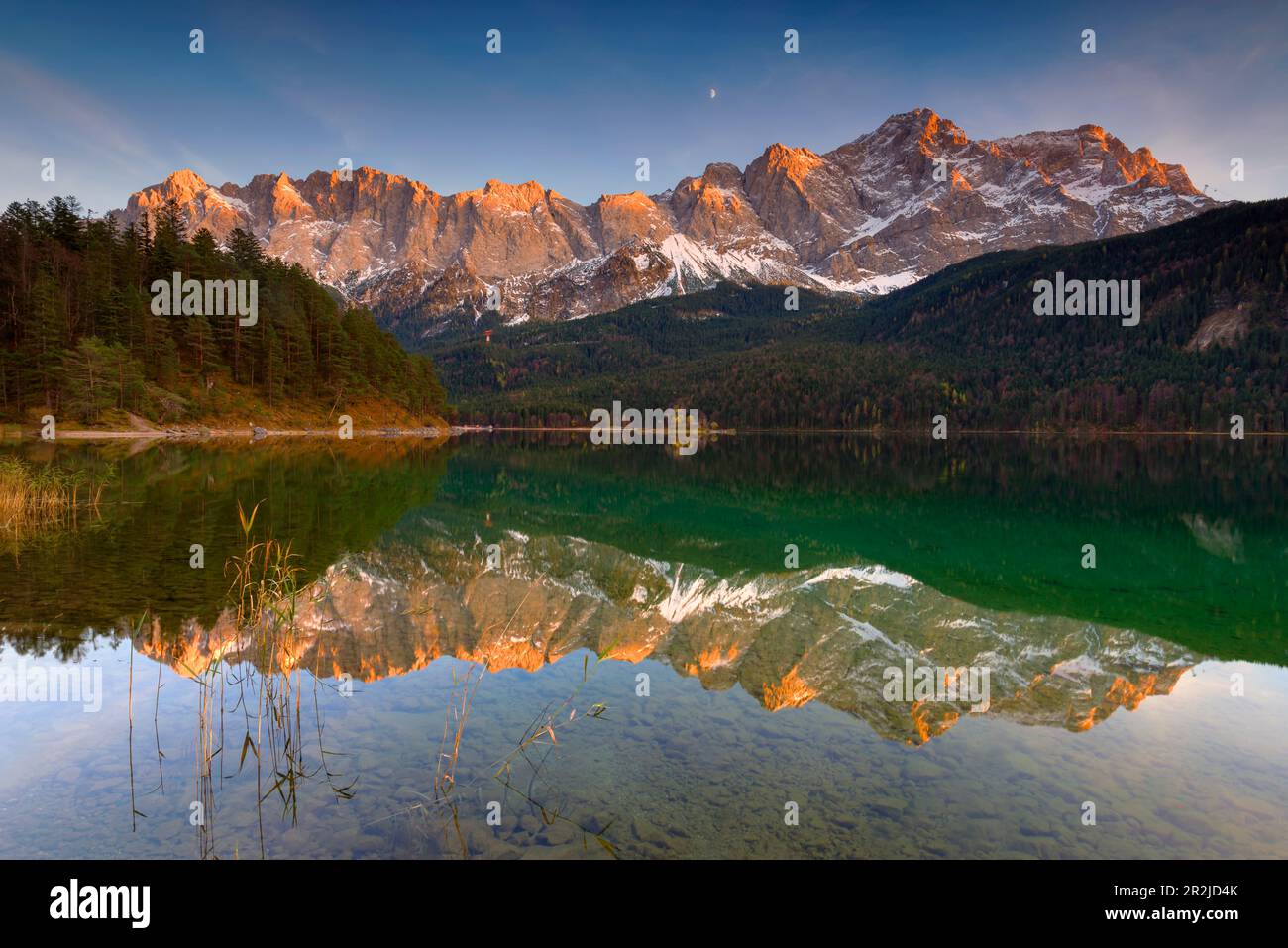 Alpenglow on the Zugspitze massif with reflection in the Eibsee Stock ...