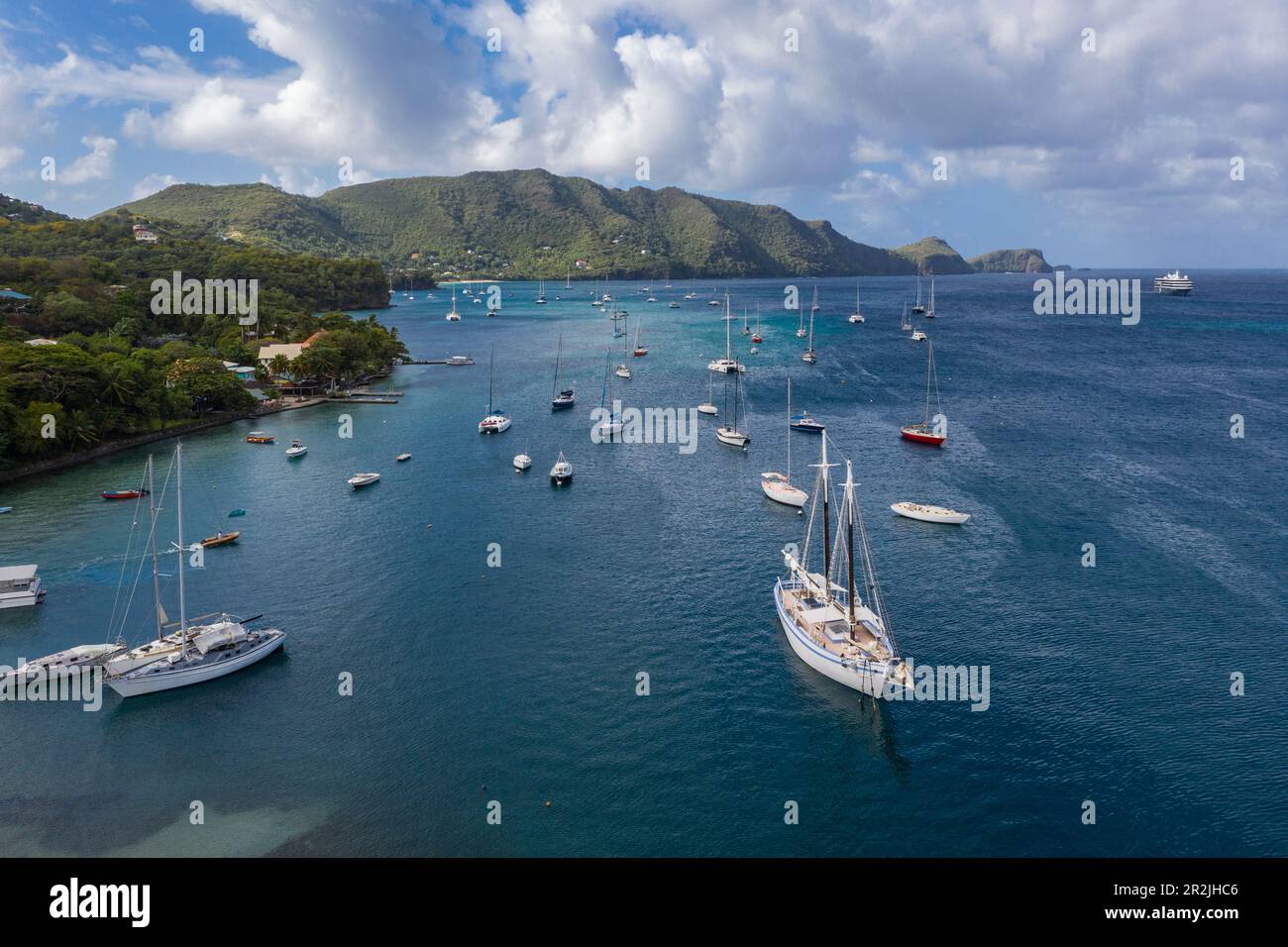 Aerial view of sailboats in port and expedition cruise ship World