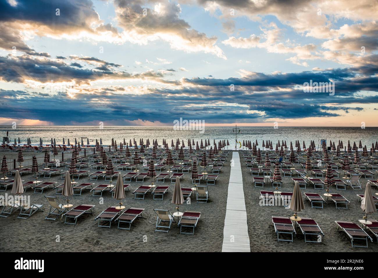 Empty beach and beach chairs, sunrise, Spotorno, Riviera di Ponente, Liguria, Italy Stock Photo