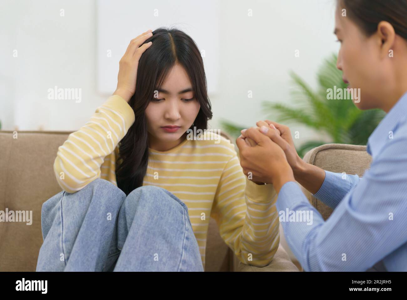 Female psychologist touching hands to comforting and encourage stress ...