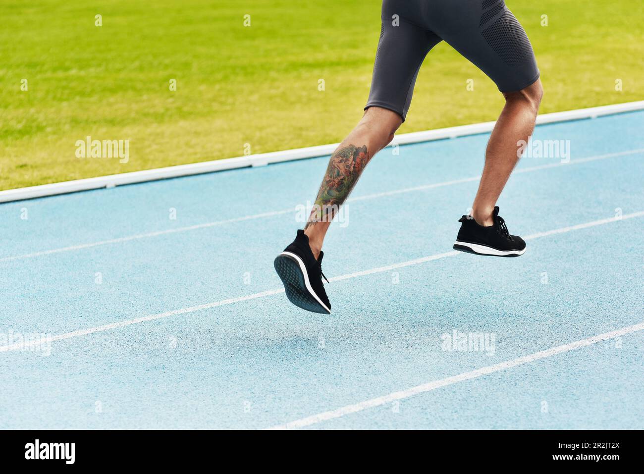 Man, legs and running on track for athletics, fitness or exercise of