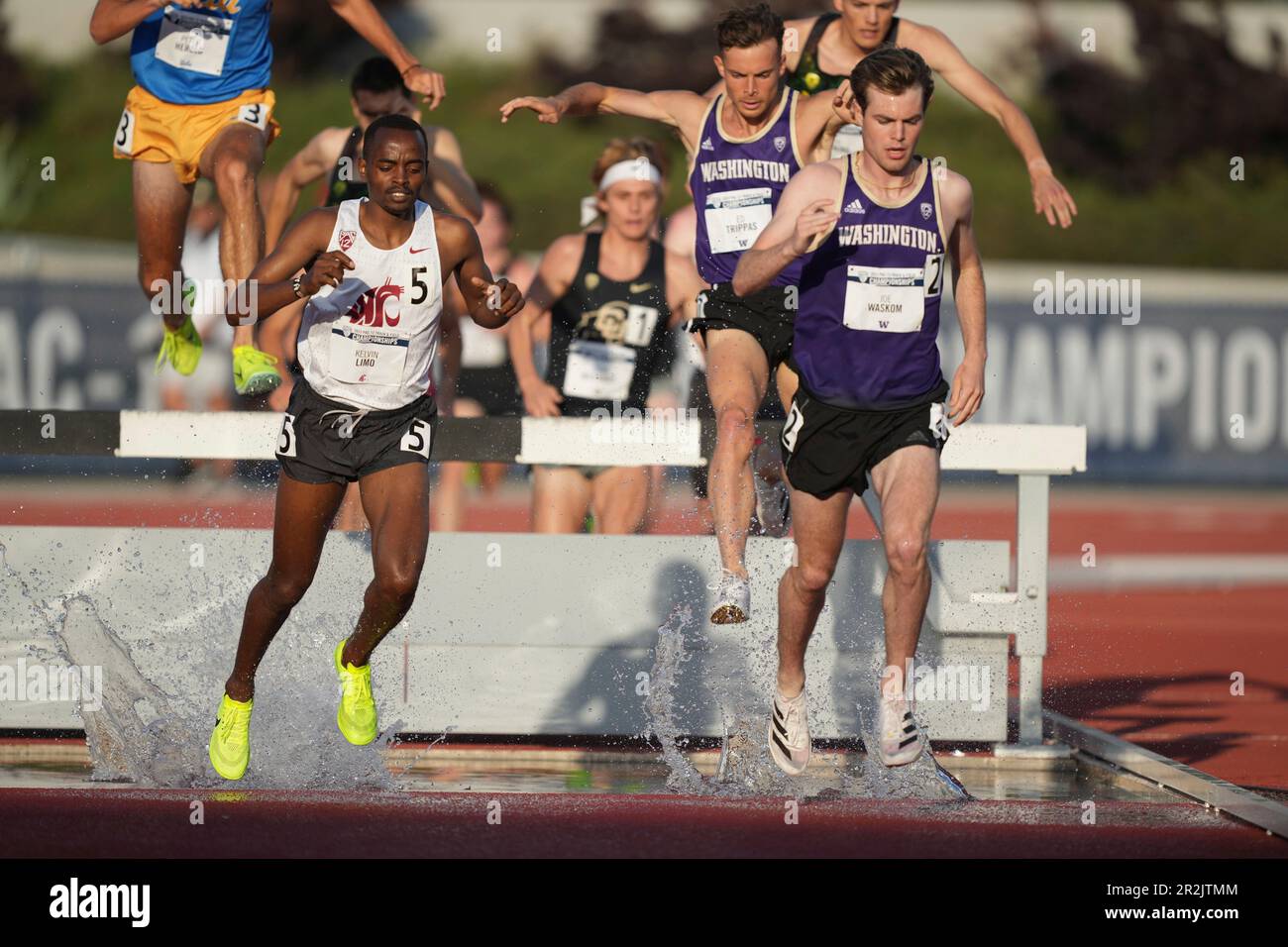 Joe Waskom of Washington and Kelvin Limo of Washington State race over