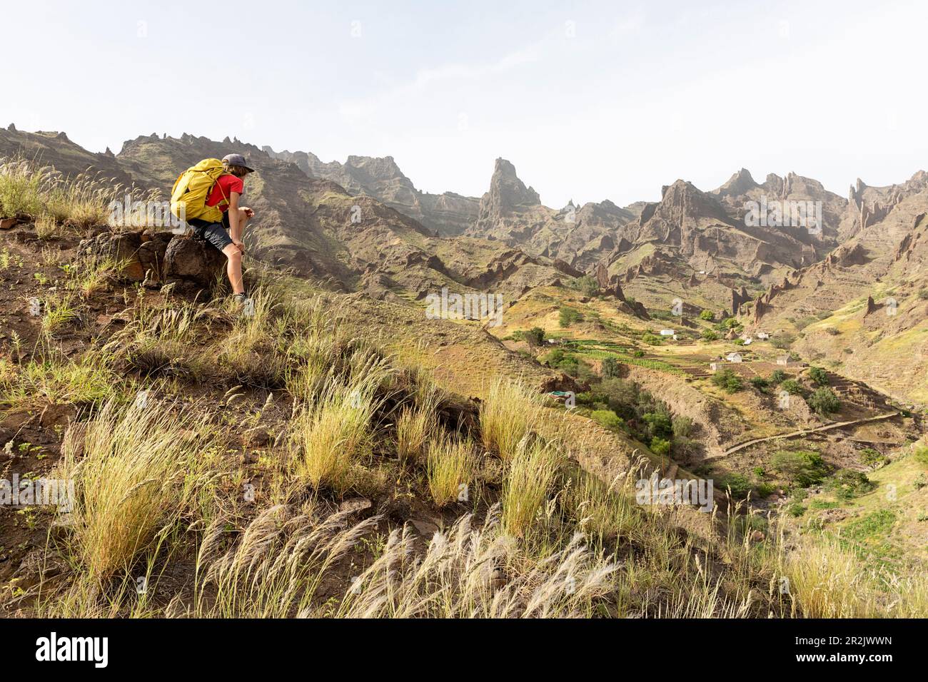 Boy, hiker, tourist looking at the spectacular landscape with strange rock formations in the interior of the Santo Antao island, Cabo verde, Africa Stock Photo