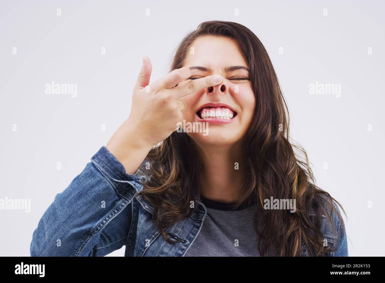 Smile, funny face and nose with a crazy woman in studio on a white