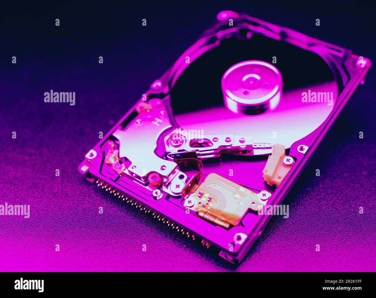 An open hard disk disassembled HDD of a computer or laptop lies on a