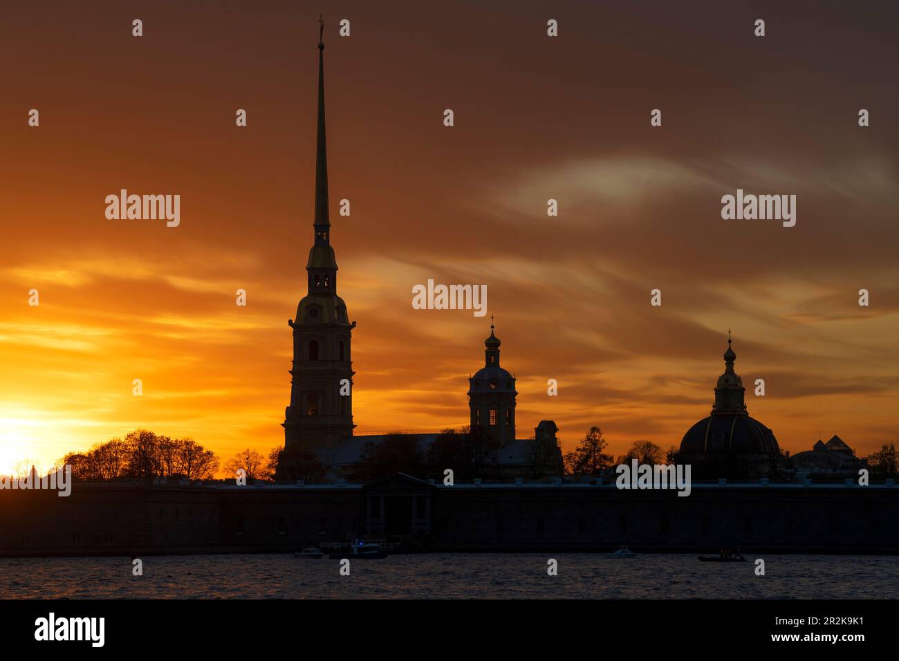 Peter and Paul Cathedral in the Peter and Paul Fortress against the background of a cloudy orange sunset. Saint Petersburg, Russia Stock Photo