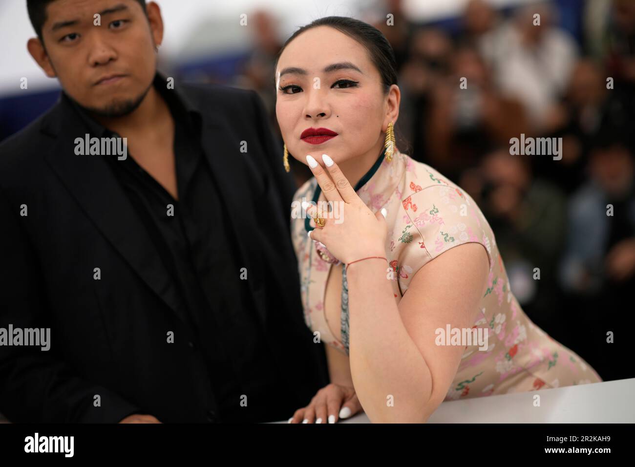 Tong Lin Kai, left, and Chloe Maayan pose for photographers at the
