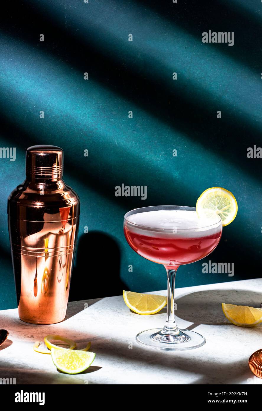 Pink lady classic cocktail drink with dry gin, grenadine syrup, lemon