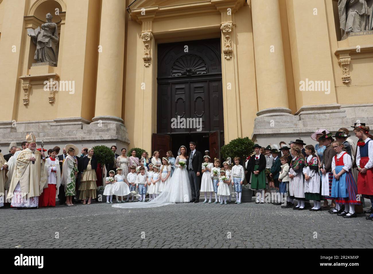 Munich, Germany. 20th May, 2023. Ludwig Prince of Bavaria and his wife Sophie-Alexandra Princess of Bavaria stand in front of the Theatinerkirche with the flower children and page boys after their church wedding - on the left is Cardinal Reinhard Marx, Archbishop of Munich and Freising. Around 1,000 guests are expected to attend the festivities. Credit: Karl-Josef Hildenbrand/dpa/Alamy Live News Stock Photo