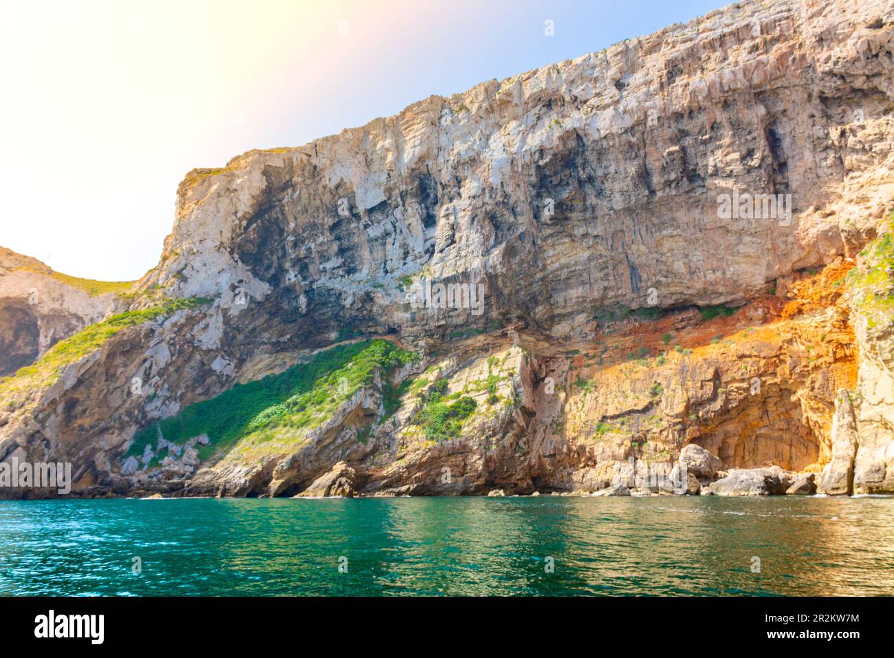 Cliffs with caves on the rocky coast of the Montgo natural park, in Denia and Javea, in Alicante, Spain Stock Photo