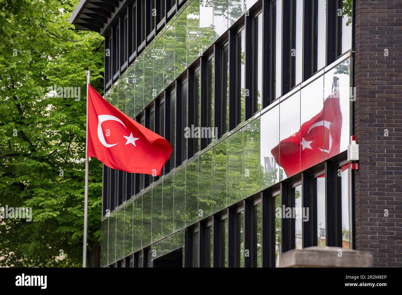 Berlin, Germany. 20th May, 2023. The Turkish flag is reflected in the facade of the Turkish Consulate General on Heerstrasse. Voting for the runoff election for the Turkish presidency has begun in Germany. Until May 24, the 1.5 million eligible voters in this country are called upon to decide at the polls between the incumbent President Erdogan and his challenger Kilicdaroglu of the CHP. Credit: Paul Zinken/dpa/Alamy Live News Stock Photo