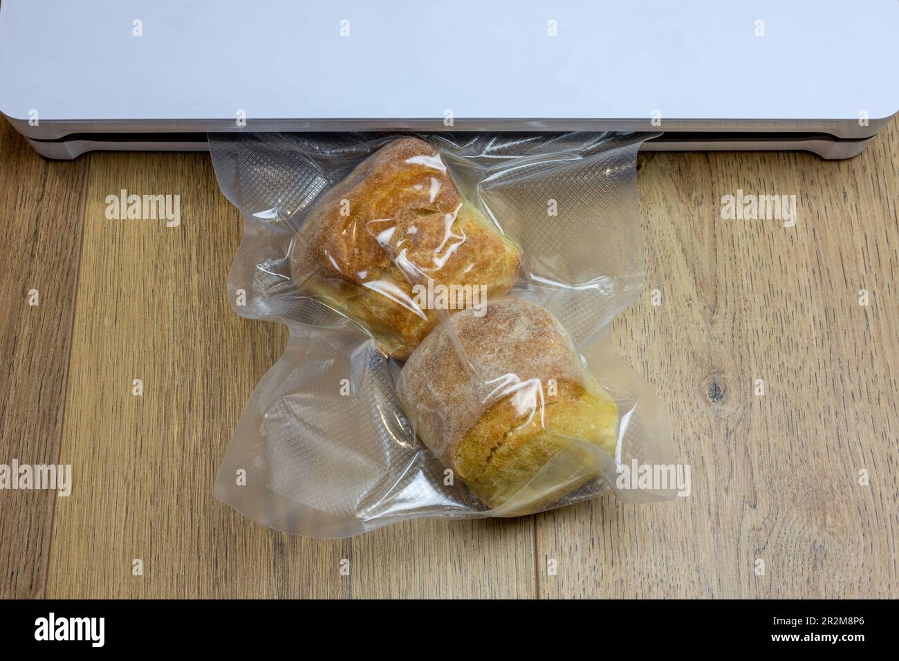 Bread packed in a vacuum package, closeup. Wooden background Stock Photo Alamy