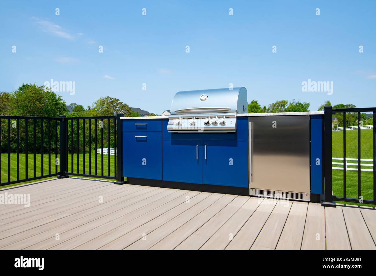 An outdoor gas grill kitchen with a refrigerator on a backyard deck in Maryland USA Stock Photo